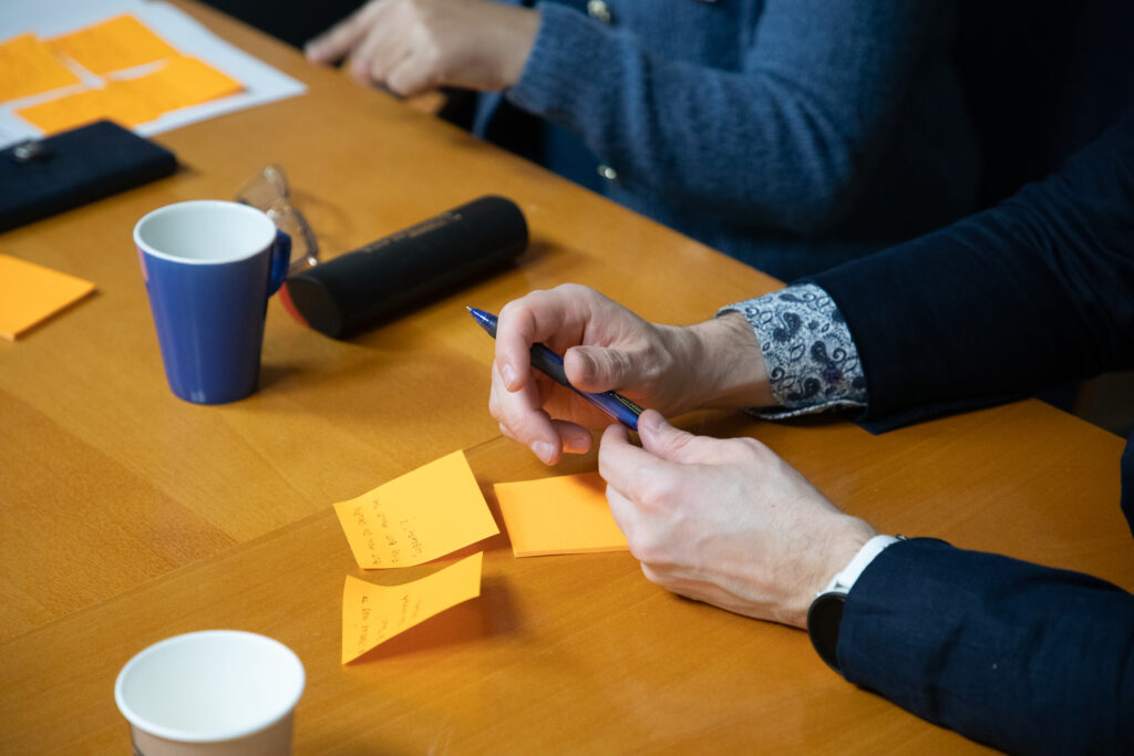 Sticky notes on the table with hands